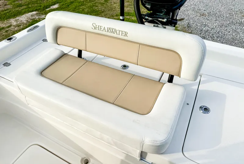 Slide: The Image of ShearWater 25LTZ 2016 boat seat with beige and white upholstery. - 12