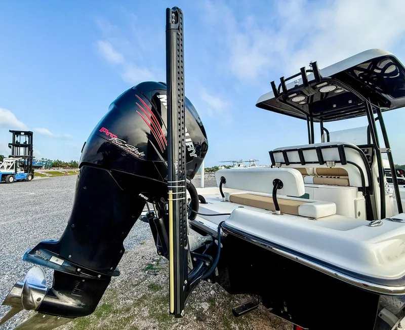 Slide: The Image of 2016 ShearWater 25LTZ boat with powerful outboard motor, parked on gravel under blue sky. - 6
