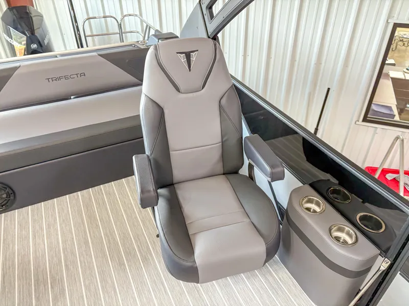 Slide: The Image of Captain's chair in 2025 Trifecta 23 UL SS Arch boat, featuring sleek design and cup holders. - 11