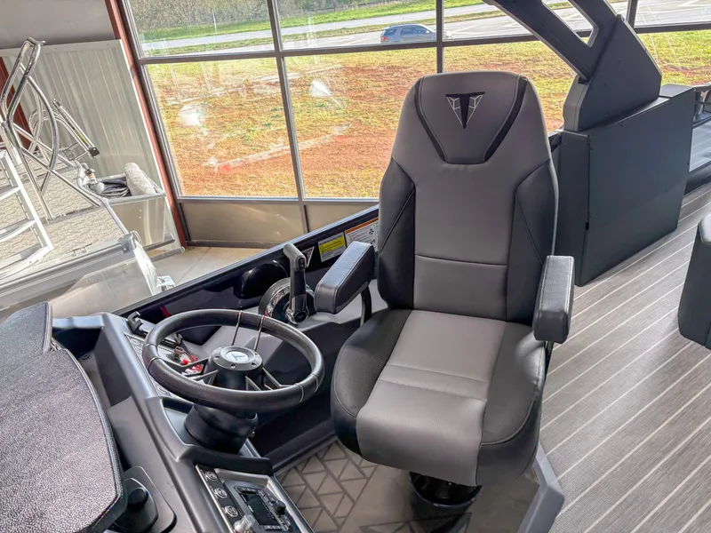 Slide: The Image of Captain's chair and steering wheel of 2025 Trifecta 23 UL SS Arch boat. - 12
