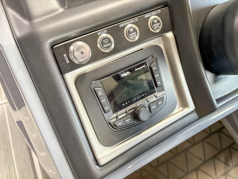 Slide: The Image of Control panel of 2025 Trifecta 23 UL SS Arch boat with audio system and lighting controls. - 13
