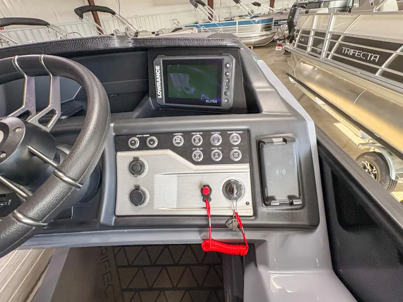 Slide: The Image of Control panel of 2025 Trifecta 23 UL SS Arch boat with steering wheel and display. - 15