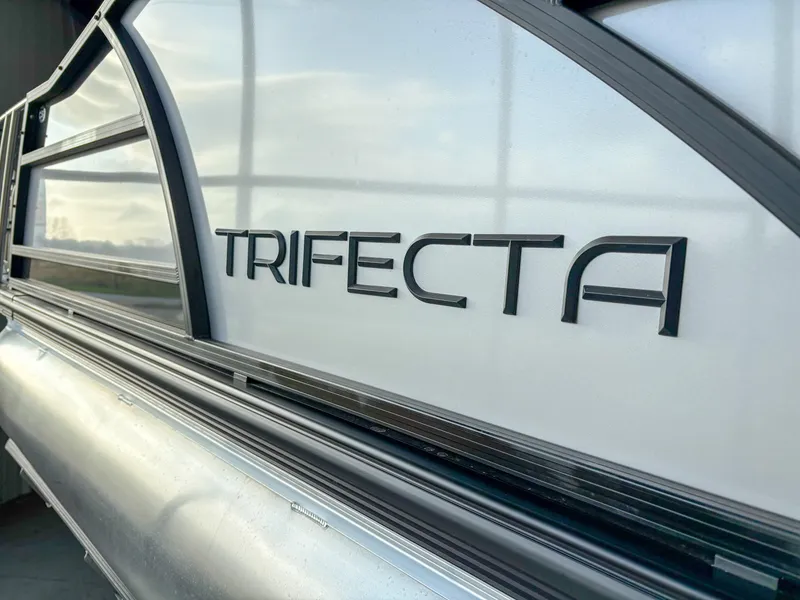 Slide: The Image of 2025 Trifecta 23 UL SS Arch boat, sleek design with prominent logo. - 5