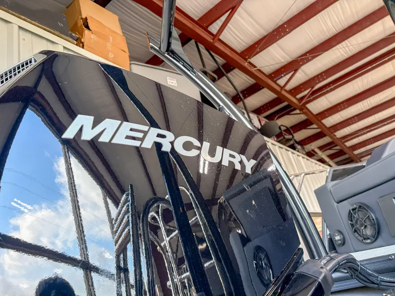 Slide: The Image of 2025 Trifecta 23 UL SS Arch boat with Mercury engine in a warehouse setting. - 6