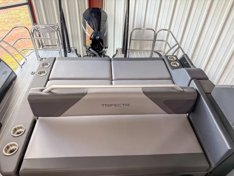 Slide: The Image of 2025 Trifecta 23 UL SS Arch boat interior with cushioned seating and cup holders. - 9