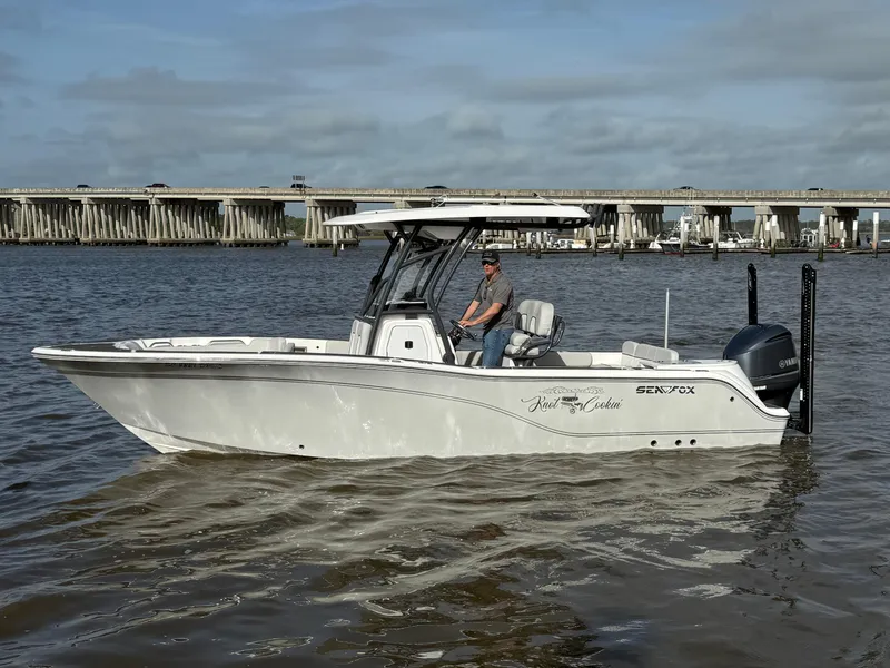 Slide: The Image of 2021 Sea Fox 248 Commander boat on water near a bridge. - 0