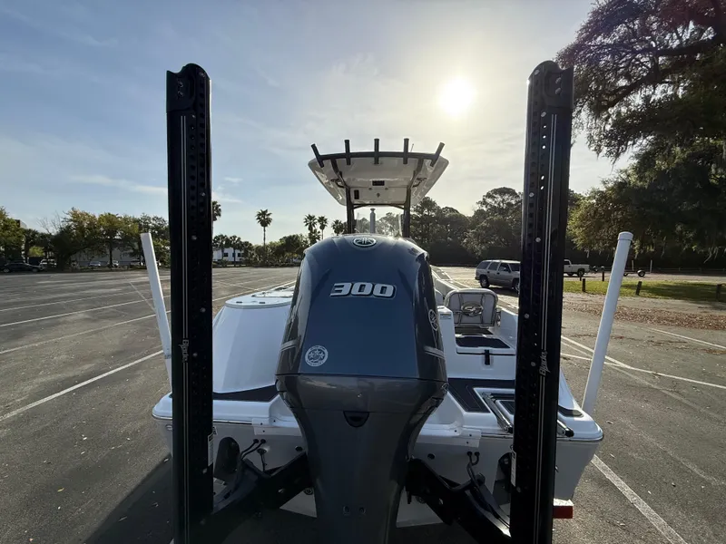 Slide: The Image of 2021 Sea Fox 248 Commander boat with powerful 300 engine, parked under sunny sky. - 11