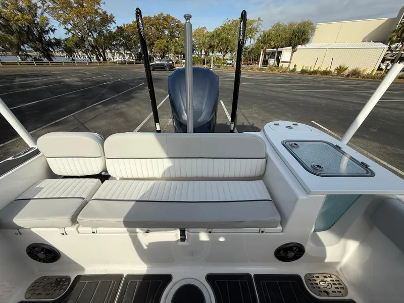Slide: The Image of 2021 Sea Fox 248 Commander boat interior with seating and storage, parked in a lot. - 27