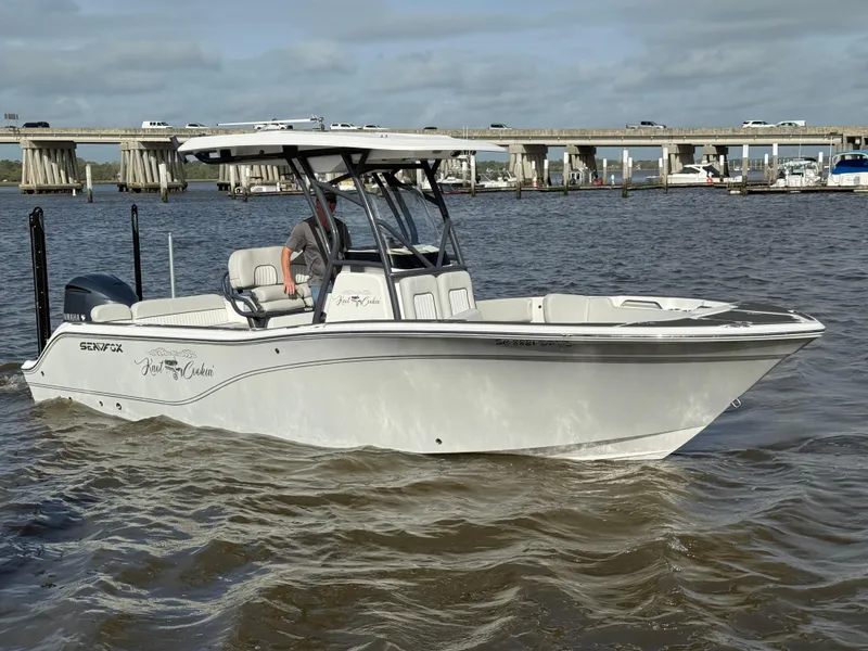Slide: The Image of 2021 Sea Fox 248 Commander boat cruising on a river near a bridge. - 3