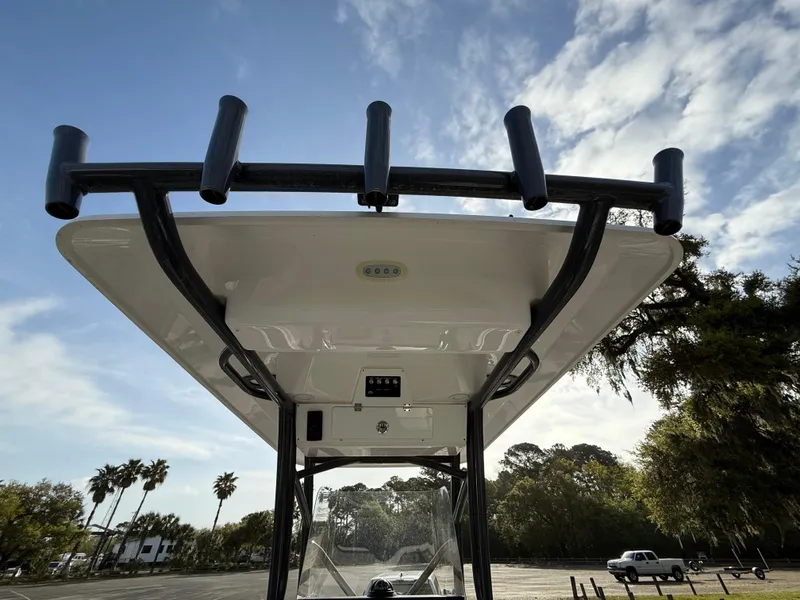 Slide: The Image of 2021 Sea Fox 248 Commander boat with rod holders, under a clear blue sky. - 30