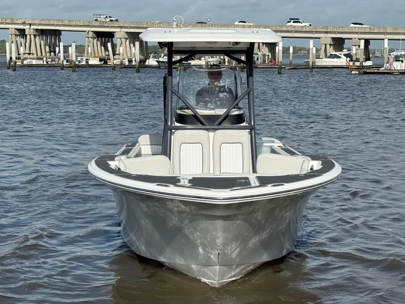 Slide: The Image of 2021 Sea Fox 248 Commander boat on water, bridge in background. - 4