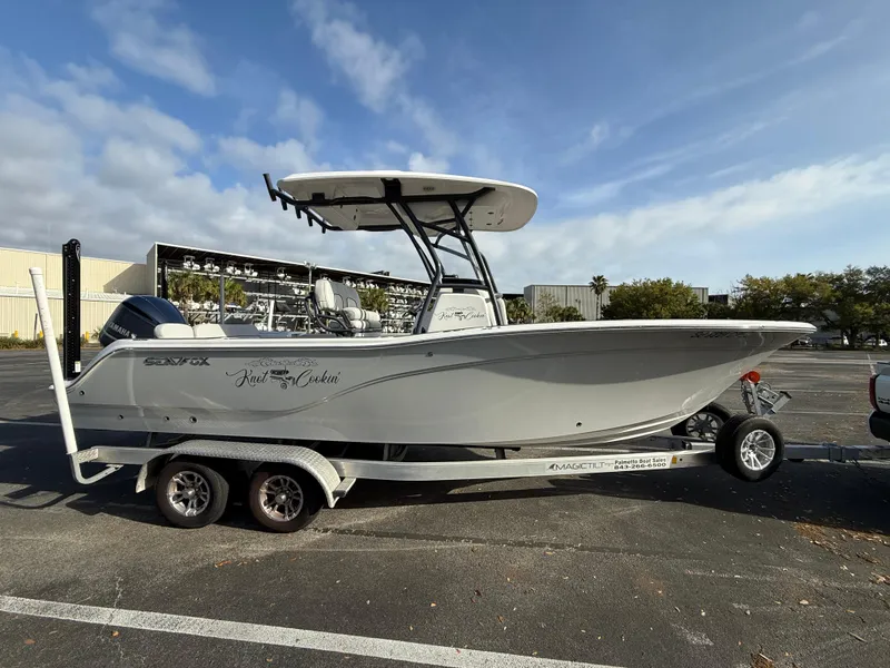 Slide: The Image of 2021 Sea Fox 248 Commander boat on trailer in parking lot, under clear sky. - 8