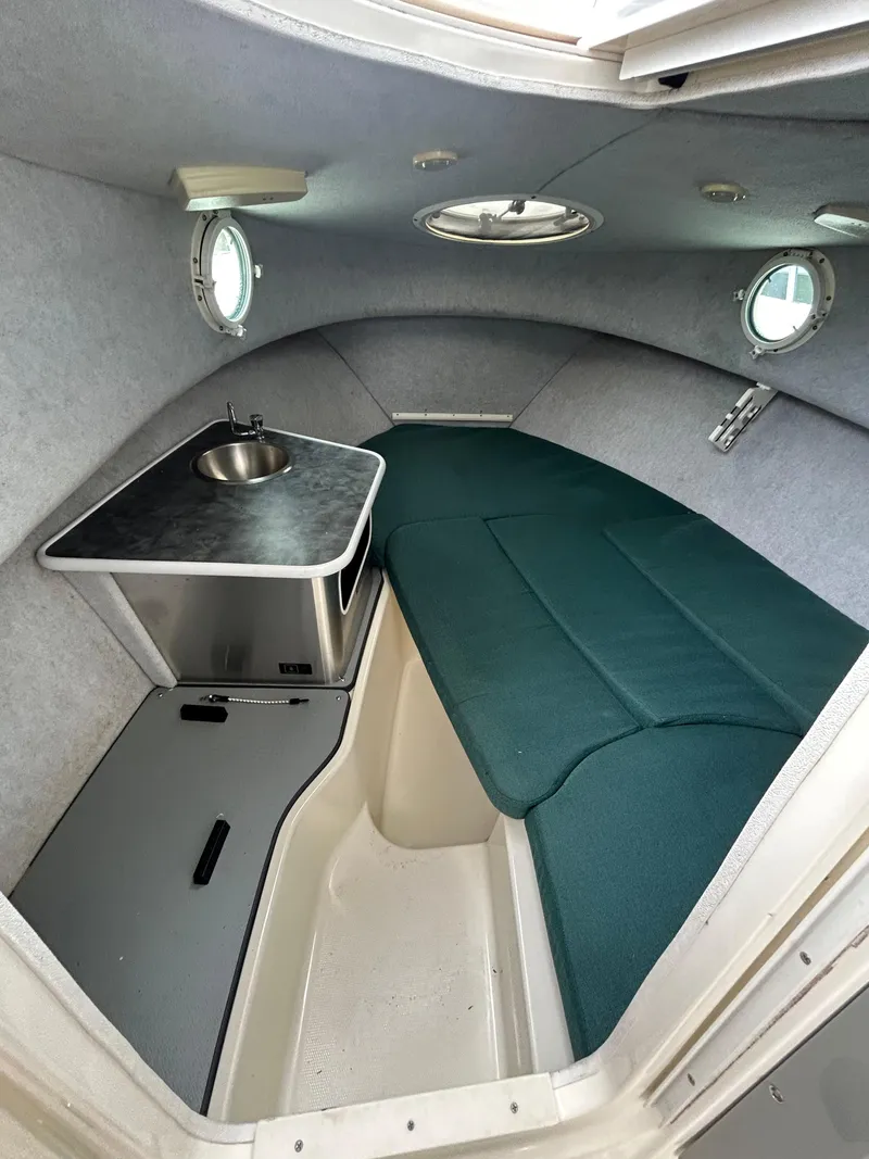 Slide: The Image of 2007 Trophy 2302 Walkaround cabin interior with sink and seating. - 11