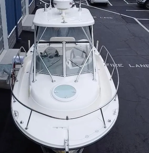 Slide: The Image of 2007 Trophy 2302 Walkaround boat, docked, aerial view, showcasing cabin and deck features. - 3