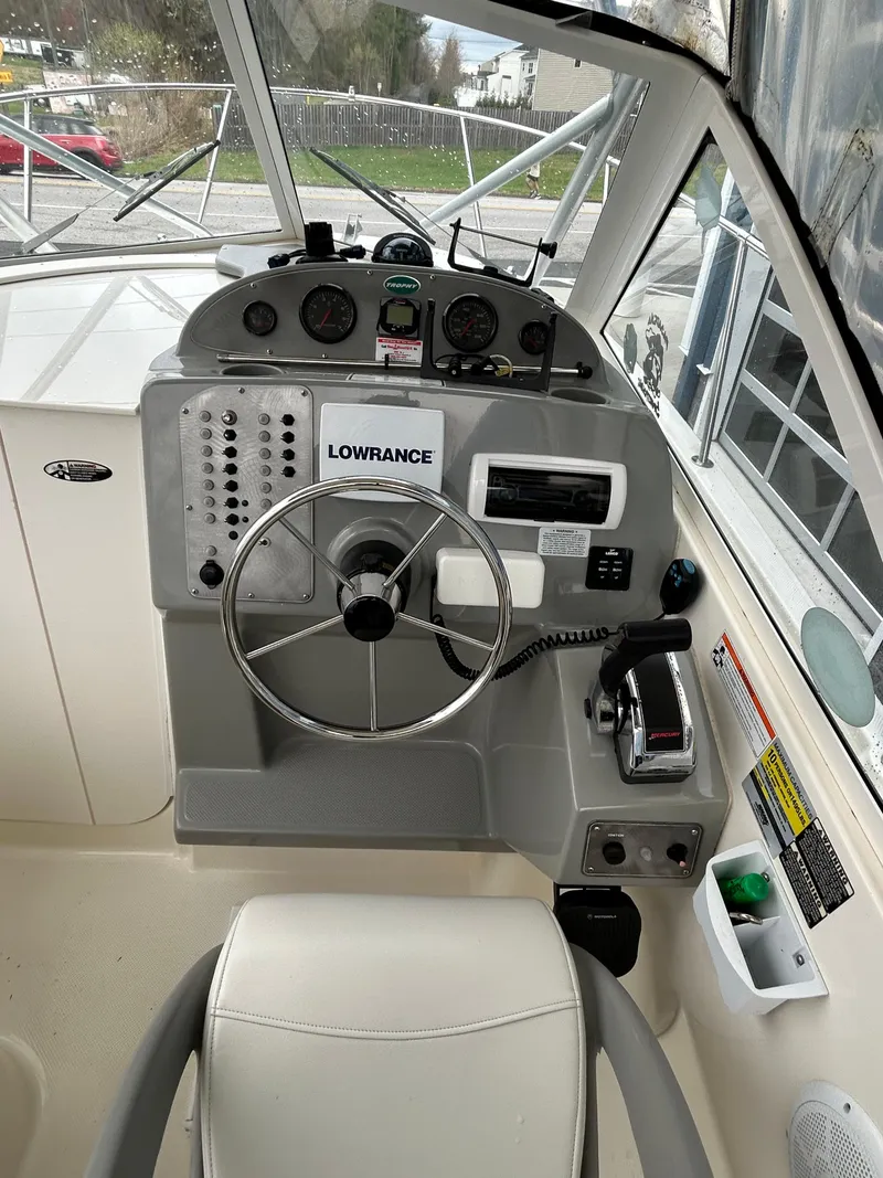 Slide: The Image of 2007 Trophy 2302 Walkaround boat helm with steering wheel and Lowrance navigation system. - 6