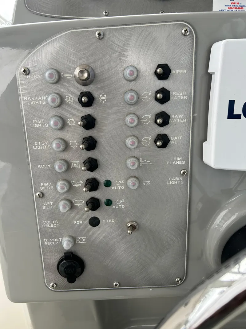 Slide: The Image of Control panel of a 2007 Trophy 2302 Walkaround boat with various switches and indicators. - 7