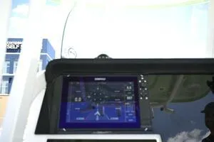 Slide: The Image of 2023 Sea Pro 239 Deep V CC boat interior with seating and console under a blue sky. - 19