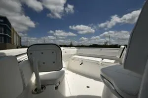 Slide: The Image of Interior view of 2023 Sea Pro 239 Deep V CC boat, featuring a control panel and storage compartment. - 36