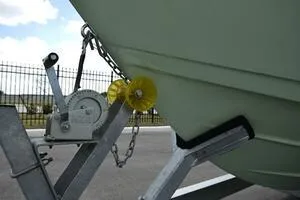 Slide: The Image of 2023 Sea Pro 239 Deep V CC boat with rod holders and speakers under a clear sky. - 47