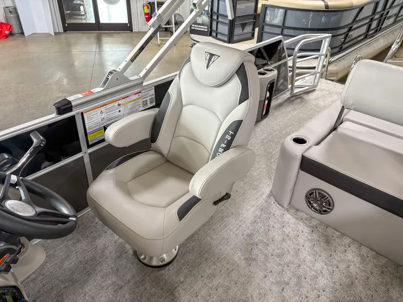Slide: The Image of 2025 Trifecta 22 UL LE T boat interior with plush captain's chair and modern design. - 11