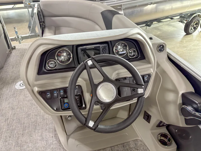 Slide: The Image of Steering console of 2025 Trifecta 22 UL LE T pontoon boat, featuring modern controls and gauges. - 15
