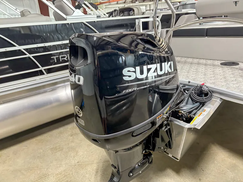 Slide: The Image of 2025 Trifecta 22 UL LE T with Suzuki outboard motor in a showroom. - 6