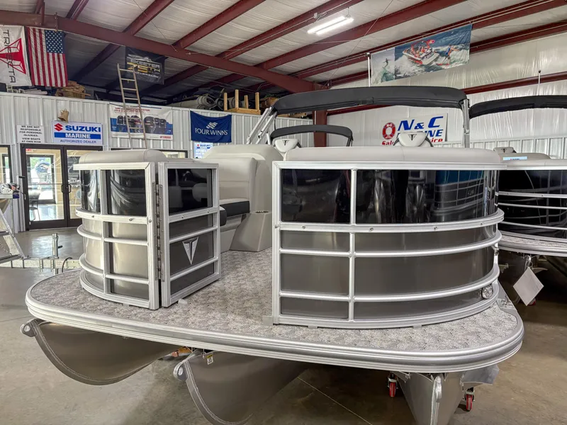 Slide: The Image of 2025 Trifecta 22 UL LE T pontoon boat displayed in a showroom with banners. - 7