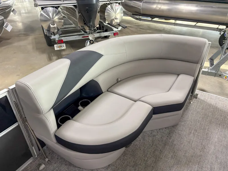 Slide: The Image of Luxurious seating on 2025 Trifecta 22 UL LE T pontoon boat, featuring sleek design and cup holders. - 9