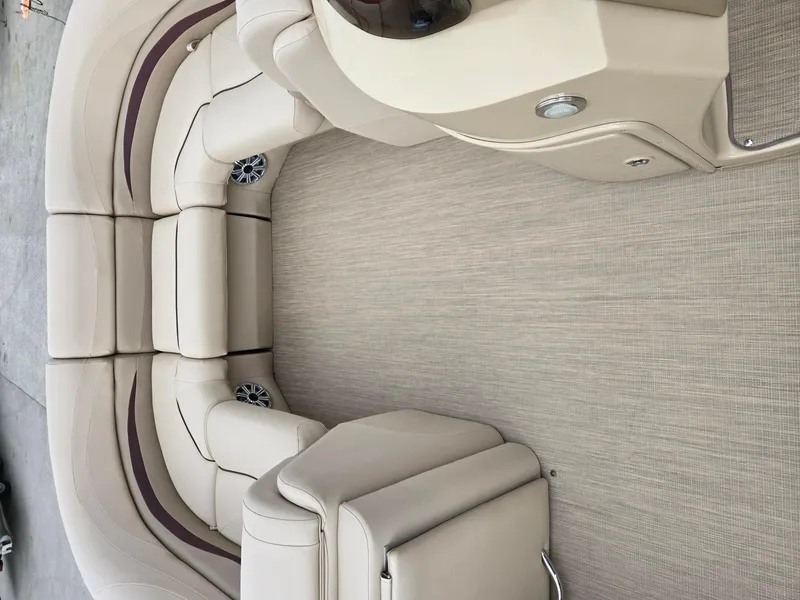 Slide: The Image of Luxurious seating on 2017 Bennington 22GSR pontoon boat, featuring beige upholstery and integrated speakers. - 15