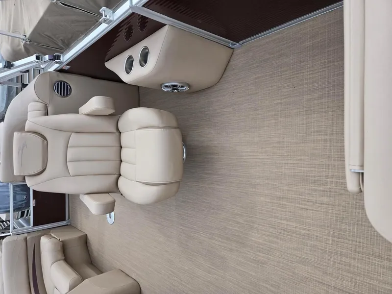 Slide: The Image of Luxurious seating on a 2017 Bennington 22GSR pontoon boat, featuring beige upholstery and cup holders. - 21