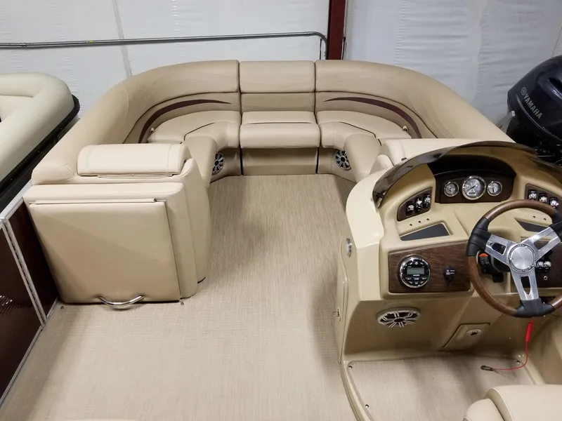 Slide: The Image of 2017 Bennington 22GSR pontoon boat interior with beige seating and steering console. - 25