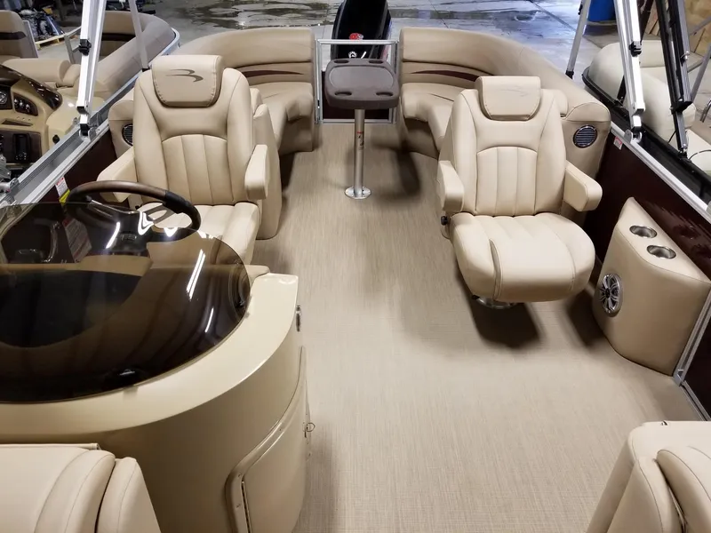 Slide: The Image of 2017 Bennington 22GSR pontoon boat interior with beige seating and steering console. - 26