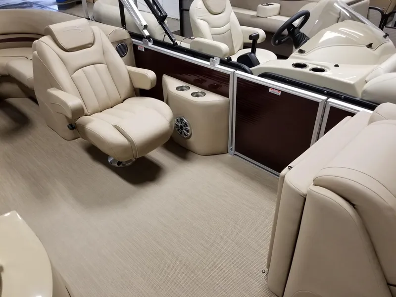 Slide: The Image of Luxurious interior of 2017 Bennington 22GSR pontoon boat with beige seating and helm. - 27