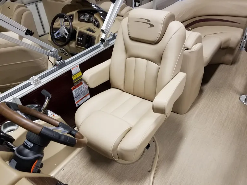 Slide: The Image of 2017 Bennington 22GSR boat interior with beige captain's chair and steering wheel. - 29