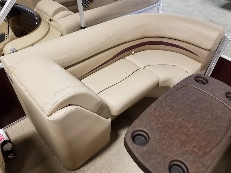 Slide: The Image of Luxurious seating on a 2017 Bennington 22GSR pontoon boat with a wooden table. - 33