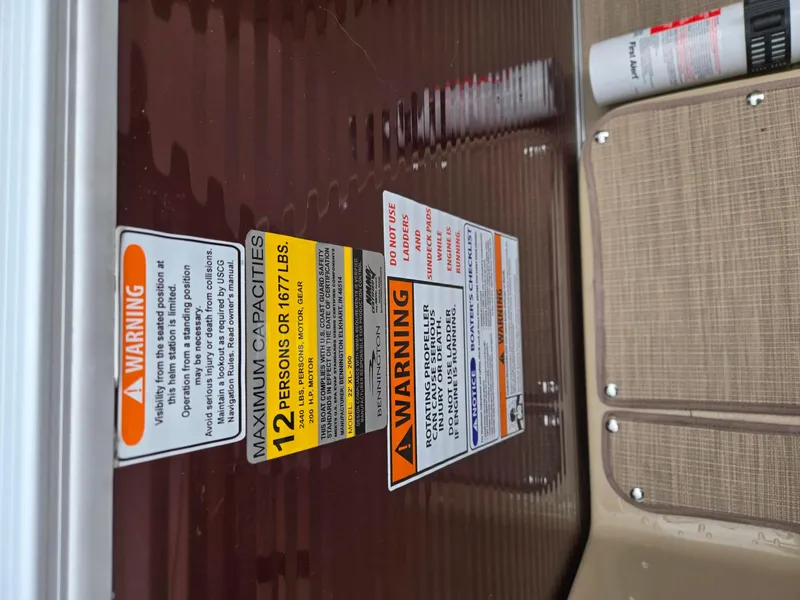 Slide: The Image of Warning labels on 2017 Bennington 22GSR boat, indicating maximum capacity and safety instructions. - 35
