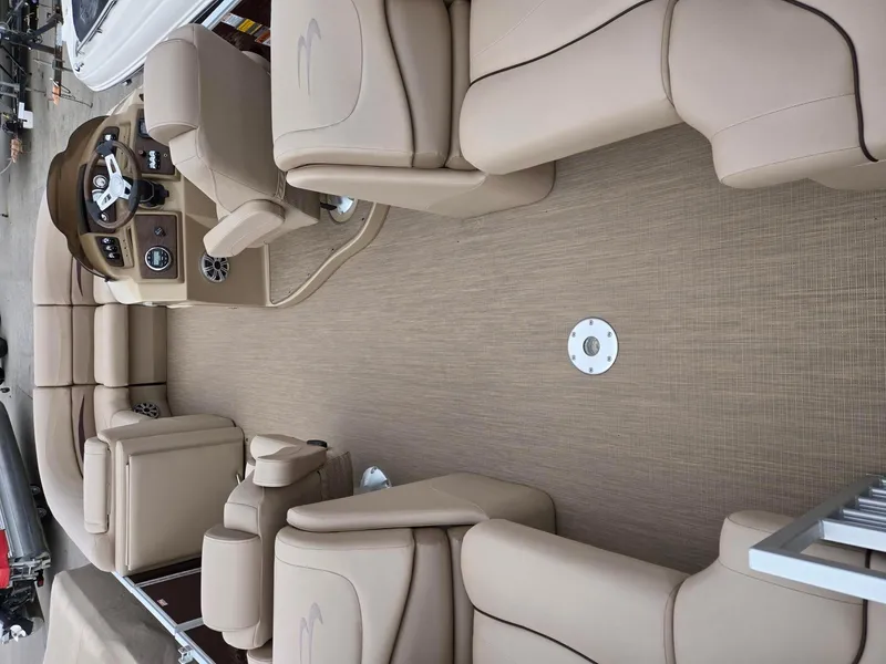 Slide: The Image of 2017 Bennington 22GSR pontoon boat interior with beige seating and steering console. - 6