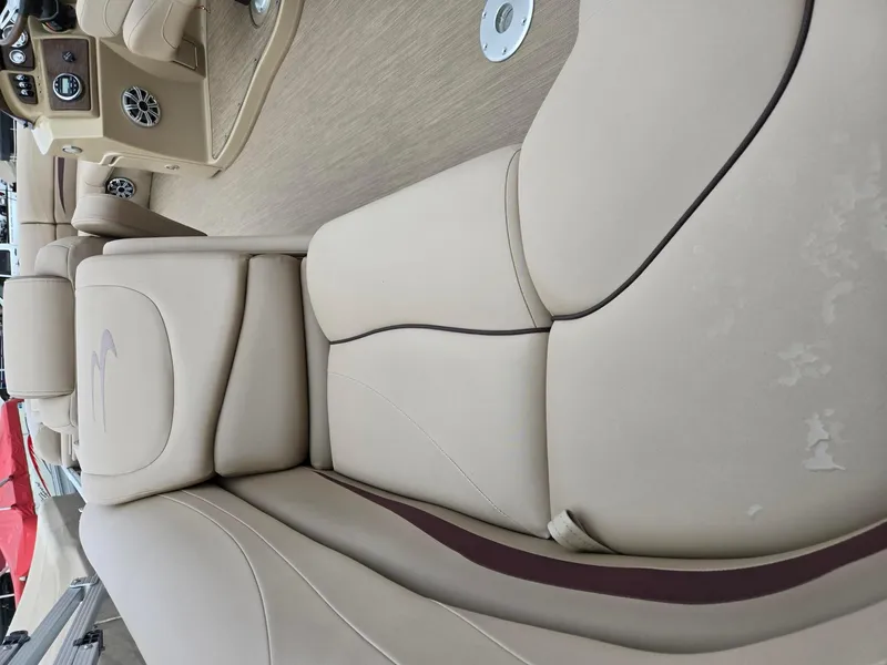 Slide: The Image of 2017 Bennington 22GSR boat interior with beige seating and dashboard. - 8