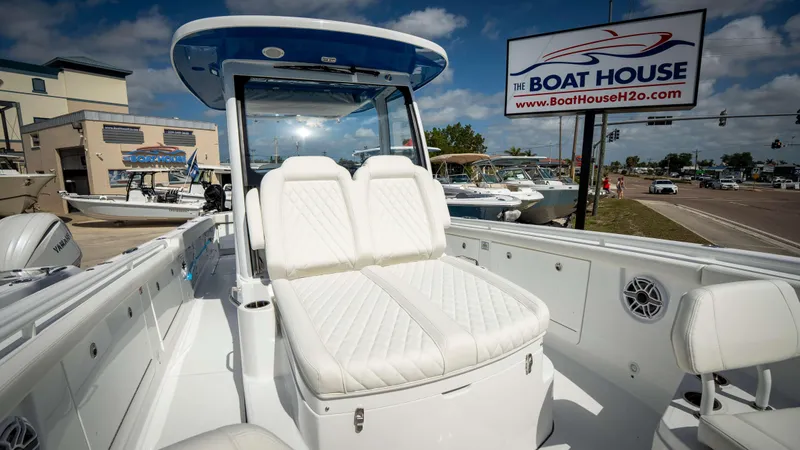 Slide: The Image of 2025 Everglades 315 CC boat at The Boat House dealership under clear skies. - 11