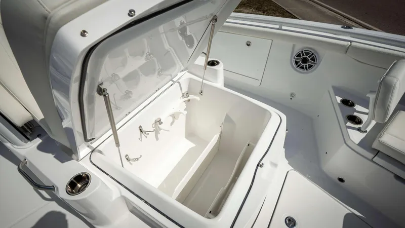 Slide: The Image of 2025 Everglades 315 CC boat interior with open storage compartment. - 14