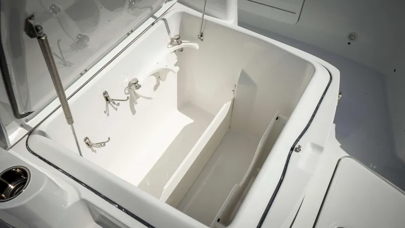 Slide: The Image of Open storage compartment on 2025 Everglades 315 CC boat, showcasing interior features. - 16