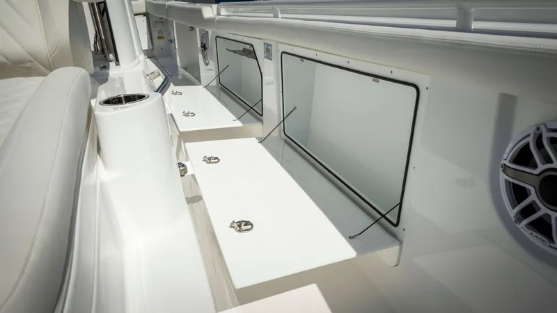Slide: The Image of 2025 Everglades 315 CC boat interior with storage compartments and speaker. - 19