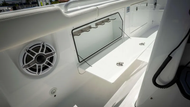 Slide: The Image of 2025 Everglades 315 CC boat interior with speaker and storage compartment. - 20