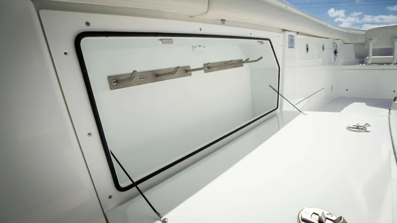 Slide: The Image of 2025 Everglades 315 CC boat interior with sleek, modern design and storage compartment. - 21