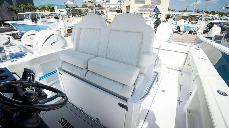 Slide: The Image of 2025 Everglades 315 CC boat with white cushioned seating and steering wheel. - 27