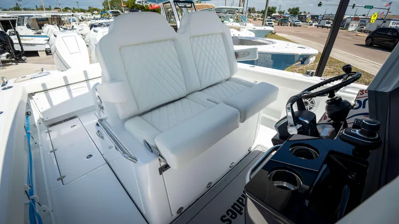Slide: The Image of 2025 Everglades 315 CC boat interior with white seating and steering console. - 28
