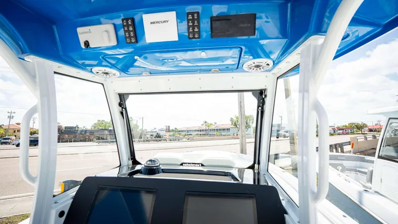 Slide: The Image of 2025 Everglades 315 CC boat interior with advanced navigation and control systems. - 30