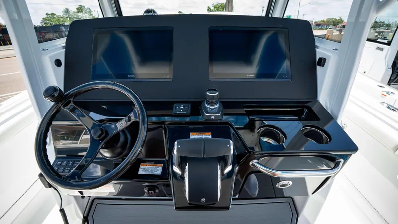 Slide: The Image of Helm of 2025 Everglades 315 CC boat with dual screens and steering wheel. - 31