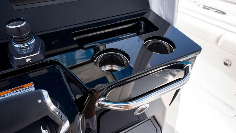 Slide: The Image of Control panel of 2025 Everglades 315 CC boat with cup holders and joystick. - 32
