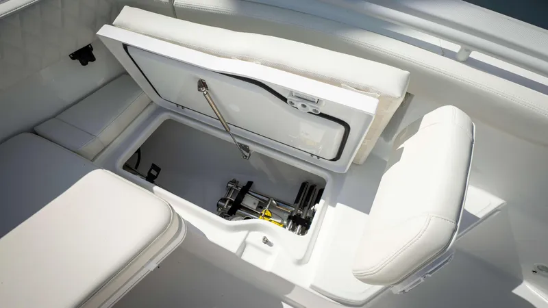 Slide: The Image of 2025 Everglades 315 CC boat storage compartment with open hatch and seating. - 8